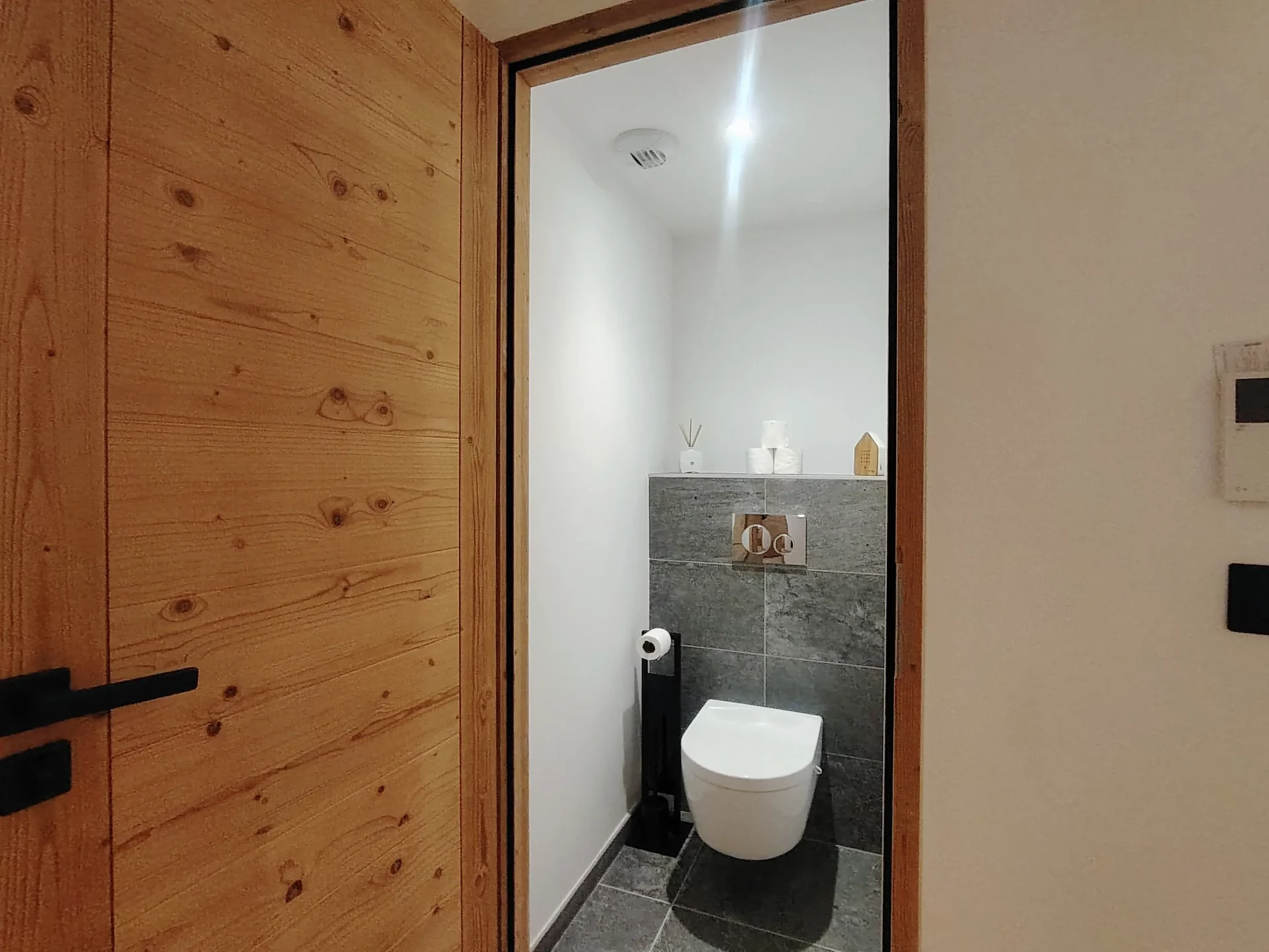 Toilettes indépendantes modernes avec carrelage en pierre grise dans l'appartement Cachemire A105 à l'Alpe d'Huez